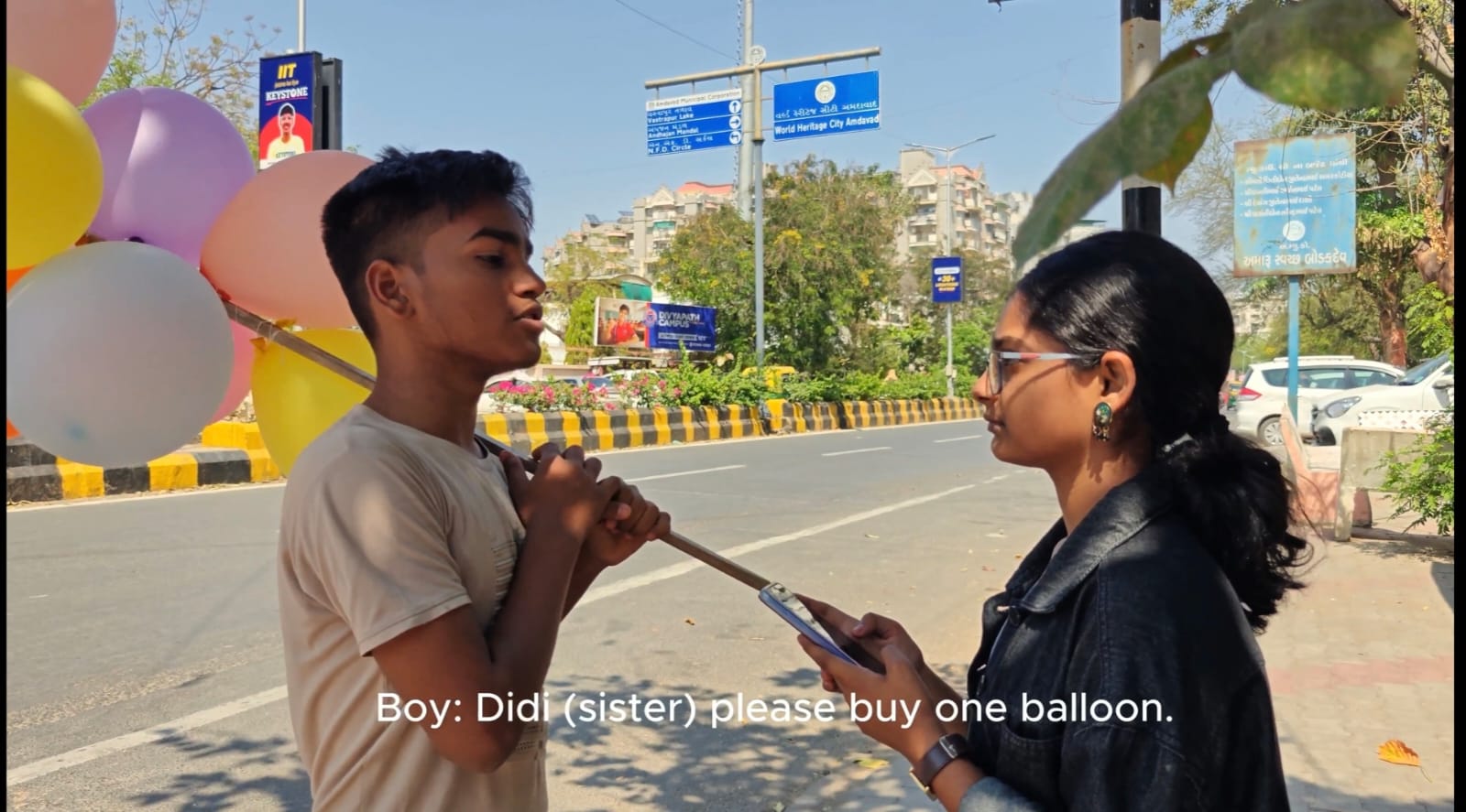 A balloon seller speaking with a woman on the roadside in Kshitij.