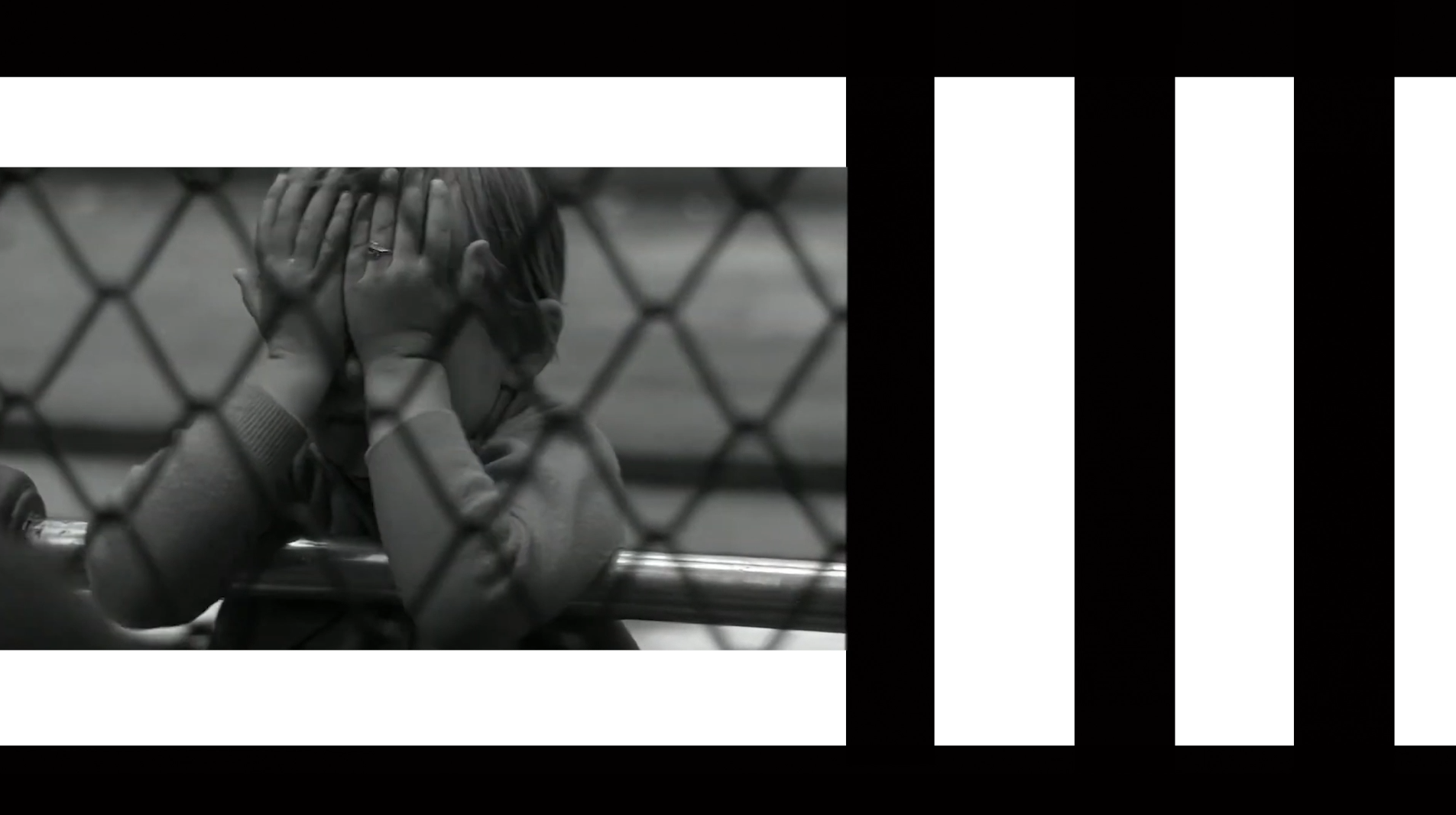 A child covering their face behind an enclosure grid in the Zoo title sequence.