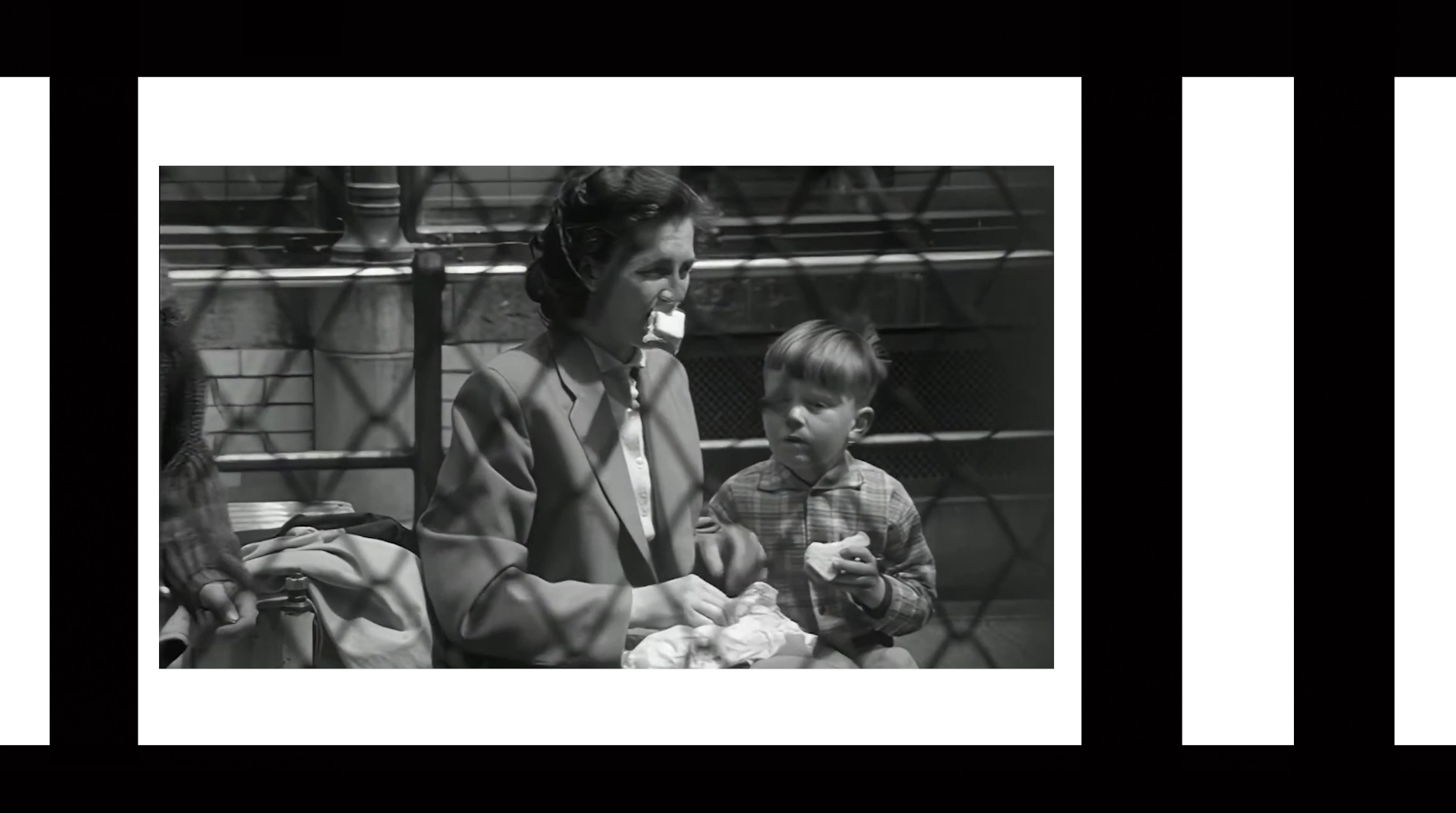 A woman and child eating inside the Zoo title sequence.